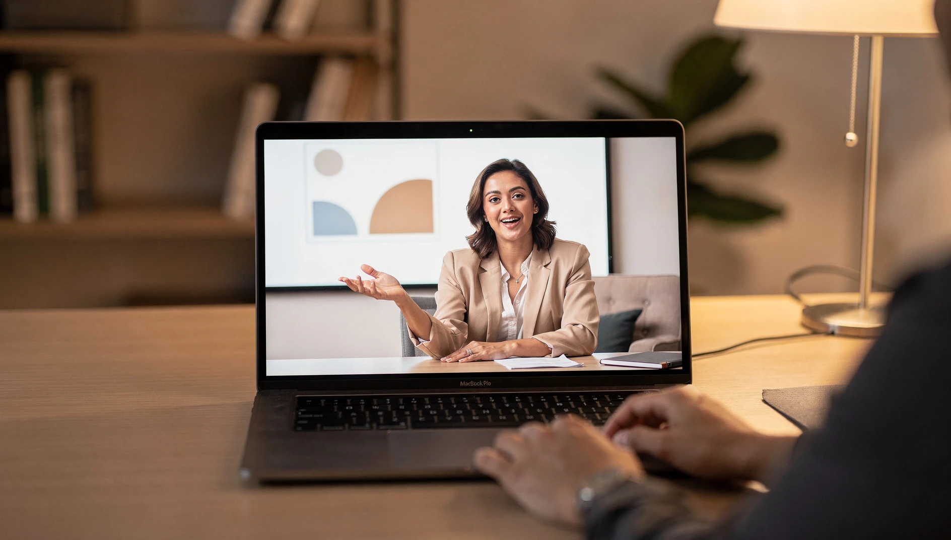 A person presenting a webinar via video call with a simple slide visible in a professional home office setting